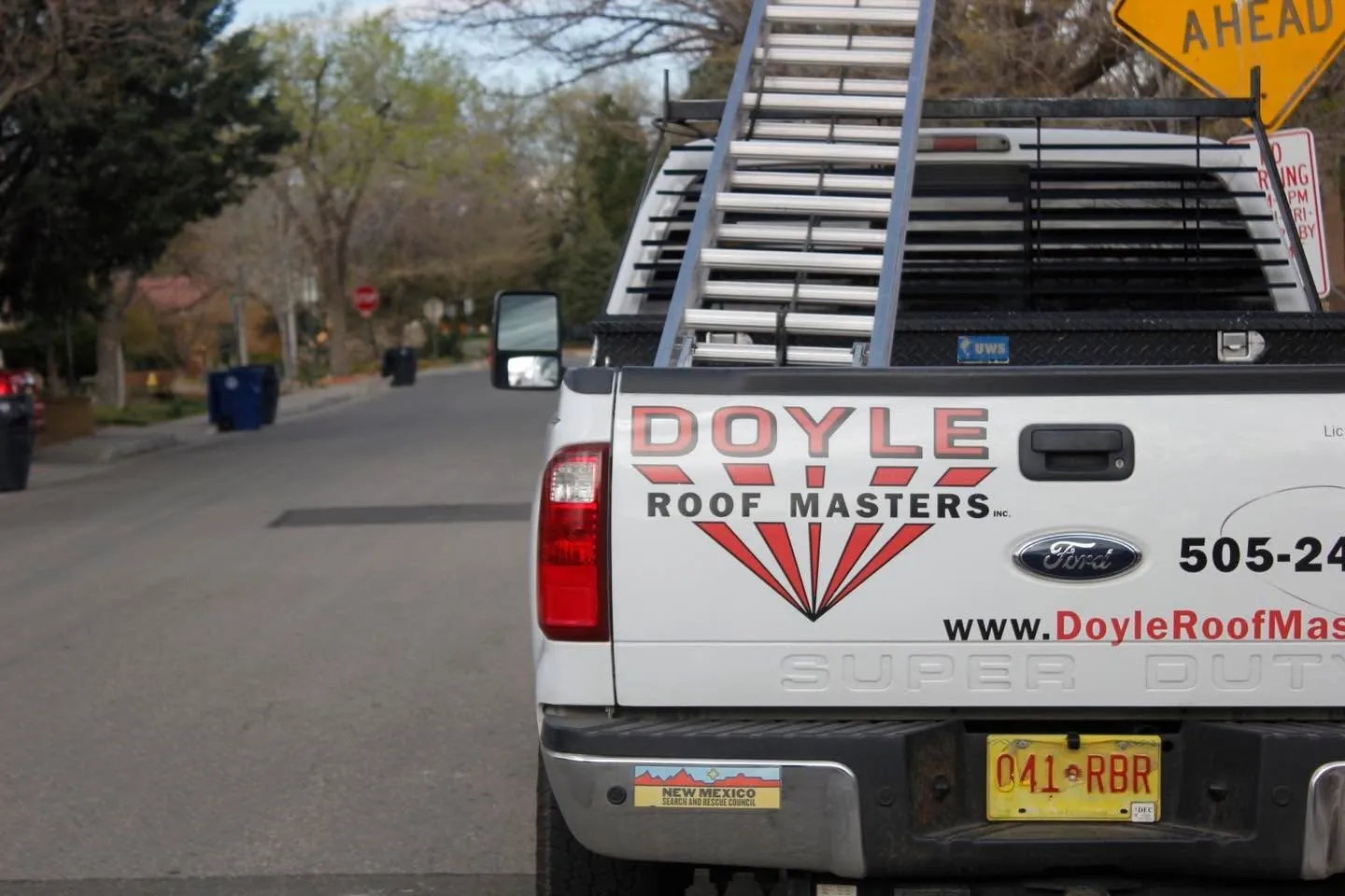 Doyle Roof Masters work truck with ladders